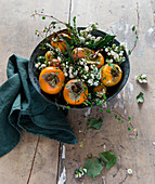 Bowl of persimmons and snowberries