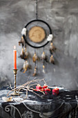 Arrangement of mystical, ethnic accessories in grey, black and red