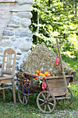 Handcart filled with straw and decorated for autumn