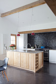 Wood-clad island counter in rustic kitchen-dining room
