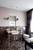 Elegant bathroom with small, dark marble tiles