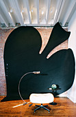 Large art installation of spades symbol on wall and floor