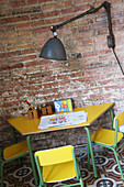 Industrial lamp above children's table and chairs