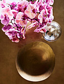 Orchid flowers and brass bowl