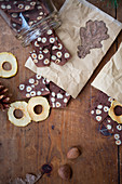 Dried apple rings and hazelnut biscuits on wooden table