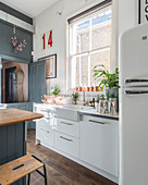 Sunny window above ceramic sink in modern country-house kitchen