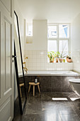 Bathroom with dark stone tiles in period building