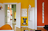 Brightly coloured walls and retro furnishings in living room