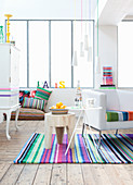 White living room with brightly striped accessories