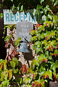 Schild an bewaschsener Fassade (Le Mas du Naoc, Cabris, Frankreich)