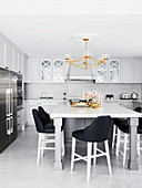 Elegant kitchen with large dining table and designer chairs