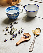 Dried flowers, spoon of honey and teacups