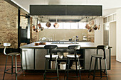 Black bar stools at industrial-style kitchen island