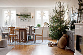 Christmas decorations and decorated tree in rustic living room