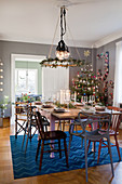Festively set table and decorated Christmas tree in dining room