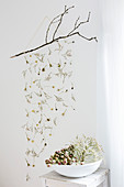 Mobile made from dried flowers hung from twig