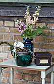 Bohemian-style arrangement with flowers and old ceramics