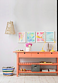 Salmon-colored console table in a feminine hallway