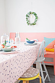 Table set in feminine pastel shades for Christmas dinner