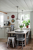 Spoke-back chair at dining table in country-house kitchen