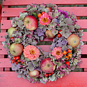 Late-summer wreath of hydrangeas, zinnias and apples