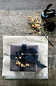Wrapped present decorated with sprig of berries