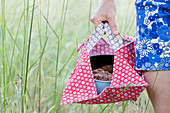 Woman carrying cake in springform pan in handmade oilcloth cake bag