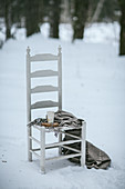 Eggnog on wooden chair in snow