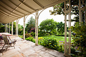 View from the veranda with natural stone floor to the garden