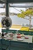 Set table on summery veranda with sea view