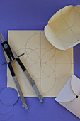 Template for origami envelope drawn on paper with compasses