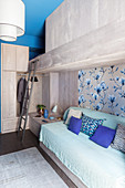 Modern, concrete bunk beds in blue and grey bedroom
