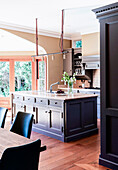 Kitchen island with gray cassette fronts in an open kitchen