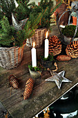 Christmas arrangement of fir sprigs, pine cones and candles