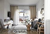 Living room in natural tones with an open patio door