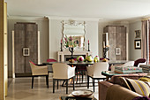 Dining chairs around dining table in dining area with pair of bespoke shagreen covered cabinets