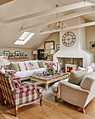 Fireplace, sofas and armchairs in attic living room