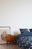 Picture of Madonna and bedside cabinet in mid-century modern style next to bed