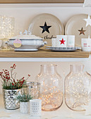 Crockery and vases on festively decorated shelves