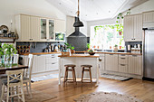 Large open-plan country-house kitchen in natural shades