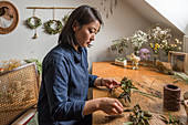 Young woman tying a wreath