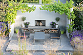 Outdoor furniture around fireplace on terrace