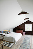 Simple bedroom in country-house style in attic room
