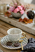 Coffee cup and chocolate biscuits on plate