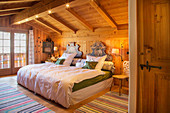 Double bed in attic bedroom in traditional Swiss farmhouse