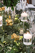 Festive candlesticks and eucalyptus branches on Christmas table