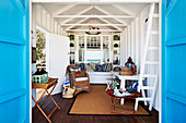 View through open blue doors into a cozy beach house