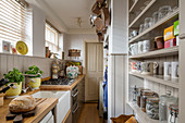 Narrow, country-house-style kitchen with wainscoting