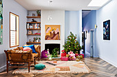Christmas decorated living room with abstract mural over fireplace