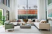Spacious sofa landscape in an architect's house with double room height